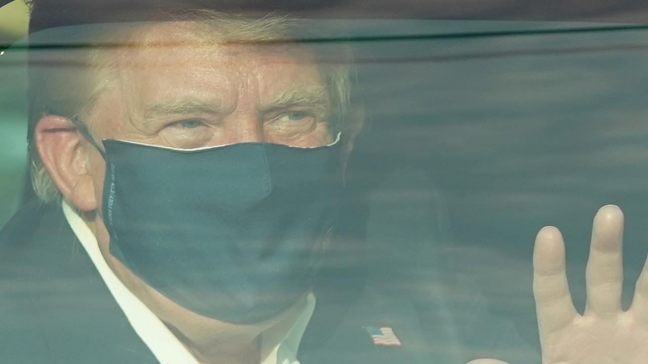President Trump during a ‘surprise visit’ outside Walter Reed Medical Center where he drove past supporters and waved hello before going back inside. Picture: Alex Edelman/AFP