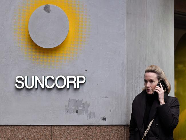 A pedestrian walks past a Suncorp Bank branch in Melbourne on July 18, 2022. - Australian banking giant ANZ announced on July 18 a 3.3 billion USD deal to swallow regional lender Suncorp Bank -- one of the biggest takeovers in the sector for more than a decade. (Photo by William WEST / AFP)