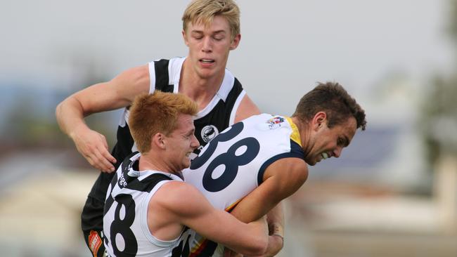 Port's Willem Drew tackles Crow's Lachlan Sholl. Picture: AAP Image/Russell Millard