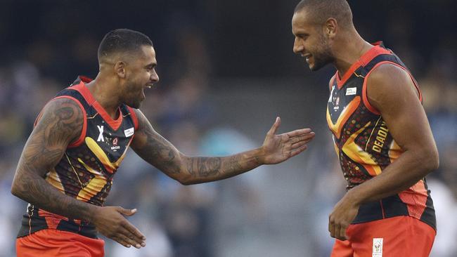 Indigenous stars Tim Kelly and Cameron Ellis-Yolmen celebrate a goal. Picture: AAP