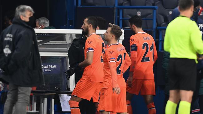 Istanbul Basaksehir's players leave the pitch after the game was suspended amid allegations of racism by one of the match officials during the UEFA Champions League group H football match between Paris Saint-Germain (PSG) and Istanbul Basaksehir FK at the Parc des Princes stadium in Paris. Picture: AFP.