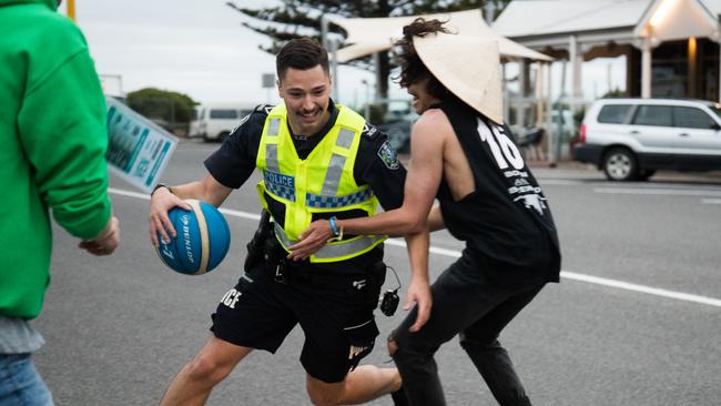 Police officer Brett plays basketball with school leavers at Schoolies in Victor Harbor. Picture: Matt Loxton