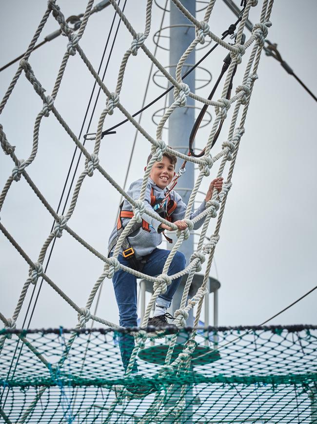 Lachlan, 12, scales to the top at the 26m-tall Mega Adventure park. Picture: Matt Loxton