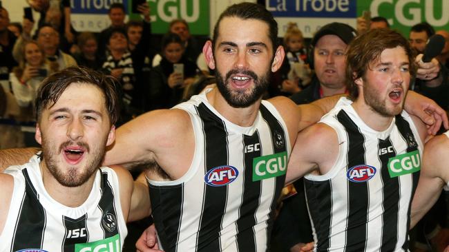 Brodie Grundy, middle, celebrates with Tom Phillips, left, and Rupert Wills, right, after Collingwood’s come-from-behind win against Carlton on Saturday. Picture: AAP Image/Hamish Blair