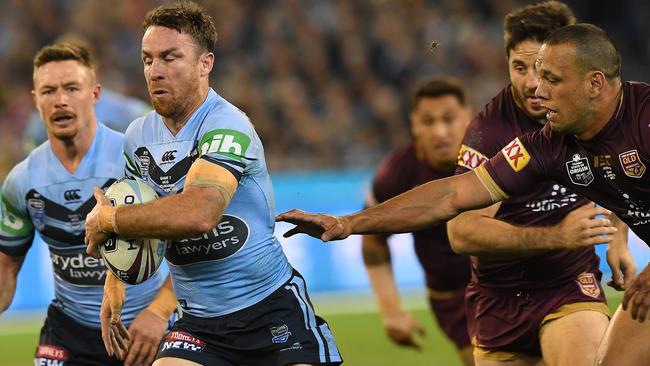 James Maloney breaks the tackle of Will Chambers on Wednesday night.