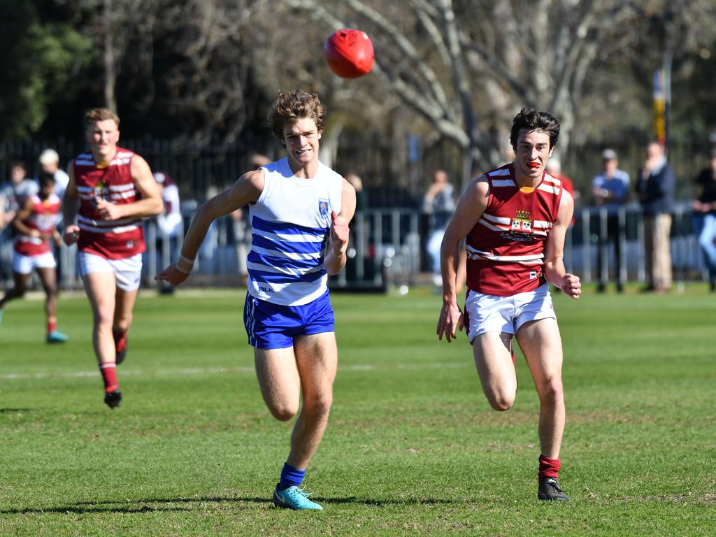 St Peter’s player Charlie Gibson and Prince Alfred’s Tom Sumner chase after the footy. Picture: AAP/ Keryn Stevens.