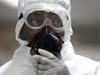 FILE - In this Aug. 4, 2014, file photo, a Nigerian health official wearing a protective suit waits to screen passengers for the Ebola virus at the arrivals hall of Murtala Muhammed International Airport in Lagos, Nigeria. Six months into the biggest-ever Ebola outbreak, scientists say they’ve learned more about how the potentially lethal virus behaves and how future outbreaks might be stopped. The first cases of Ebola were reported in Guinea by the World Health Organization on March 23 before spreading to Sierra Leone, Liberia and elsewhere. (AP Photo/Sunday Alamba, File)