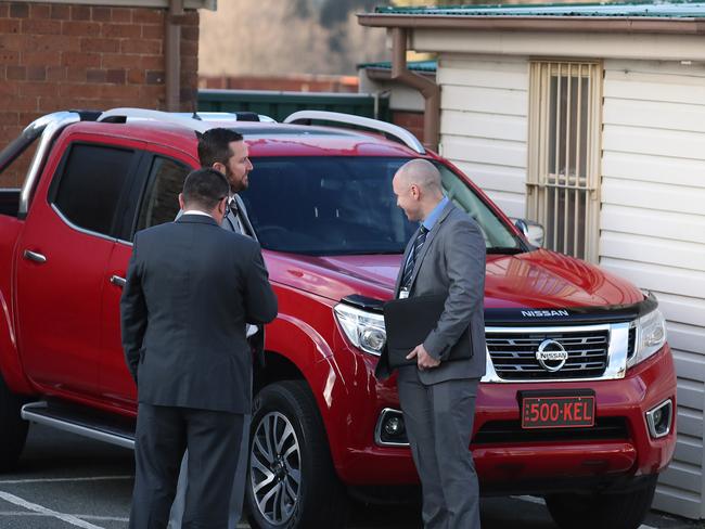 Homicide officers Detective Sergeant Luke Scott, Detective Senior Constable Matt Fitzgerald and another officer wait for Bassam Hamzy to arrive at Goulburn Police Station on Wednesday. Picture Gary Ramage