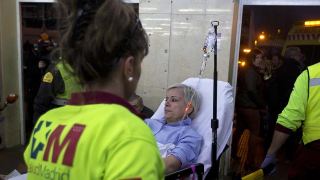An injured passenger is taken from a train station to an ambulance in Alcala de Henares, central Spain. Picture: AP