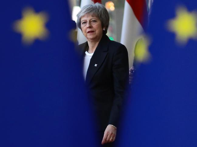 ***BESTPIX*** BRUSSELS, BELGIUM - DECEMBER 13: Britains Prime Minister Theresa May is seen behind EU flags as she arrives at the European Council for the start of the two day EU summit on December 13, 2018 in Brussels, Belgium. Mrs May yesterday won a vote of confidence in her leadership among her own MPs 200 to 117. Attending the summit she will attempt to secure greater assurances on the temporary nature of the Irish Backstop, in turn hoping to persuade MPs to vote her Brexit Deal through Parliament in the coming weeks. (Photo by Dan Kitwood/Getty Images)