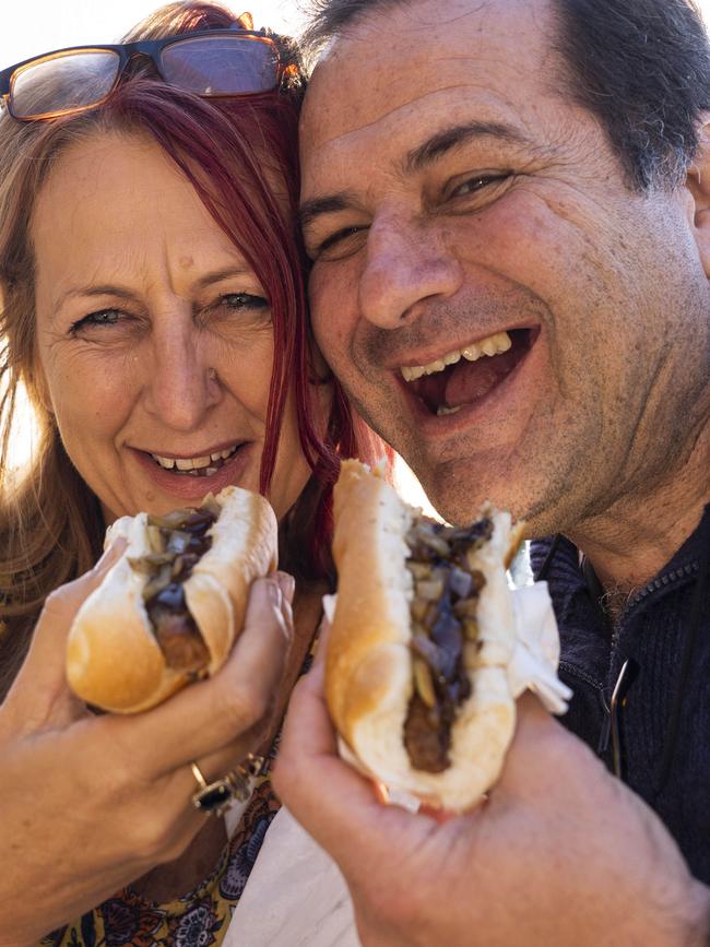 Locals Raelene Waters and Michael Tammetta enjoy their sausage sizzle. Picture: Matthew Vasilescu