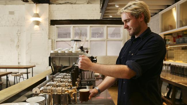 Cam Stephens pours a nitro coffee at Mecca Coffee, Alexandria. Picture: Justin Lloyd