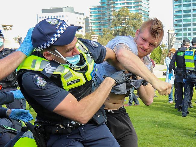 Protestors against lockdown laws clash with police at the Shrine Of Remembrance in Melbourne. A policeman is punched in the face by a protestor later arrested. Picture: Alex Coppel.