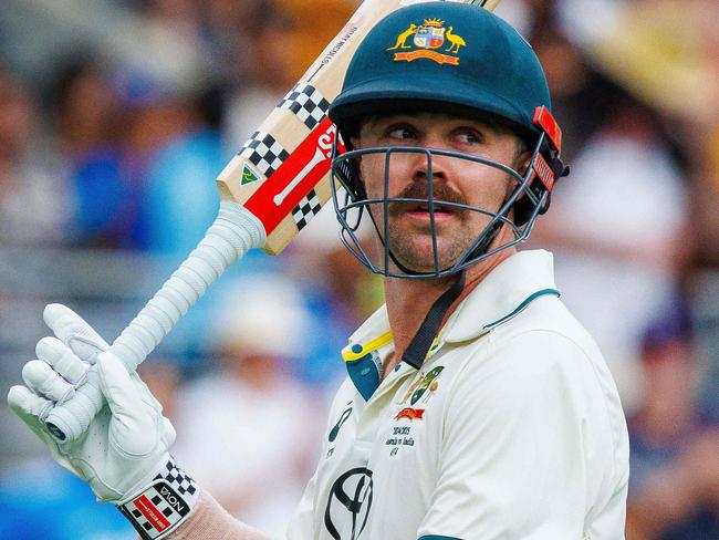 Australia's Travis Head acknowledges the crowd as he departs after being dismissed by India's Jasprit Bumrah on day two of the third cricket Test match between Australia and India at The Gabba in Brisbane on December 15, 2024. (Photo by Patrick HAMILTON / AFP) / -- IMAGE RESTRICTED TO EDITORIAL USE - STRICTLY NO COMMERCIAL USE --