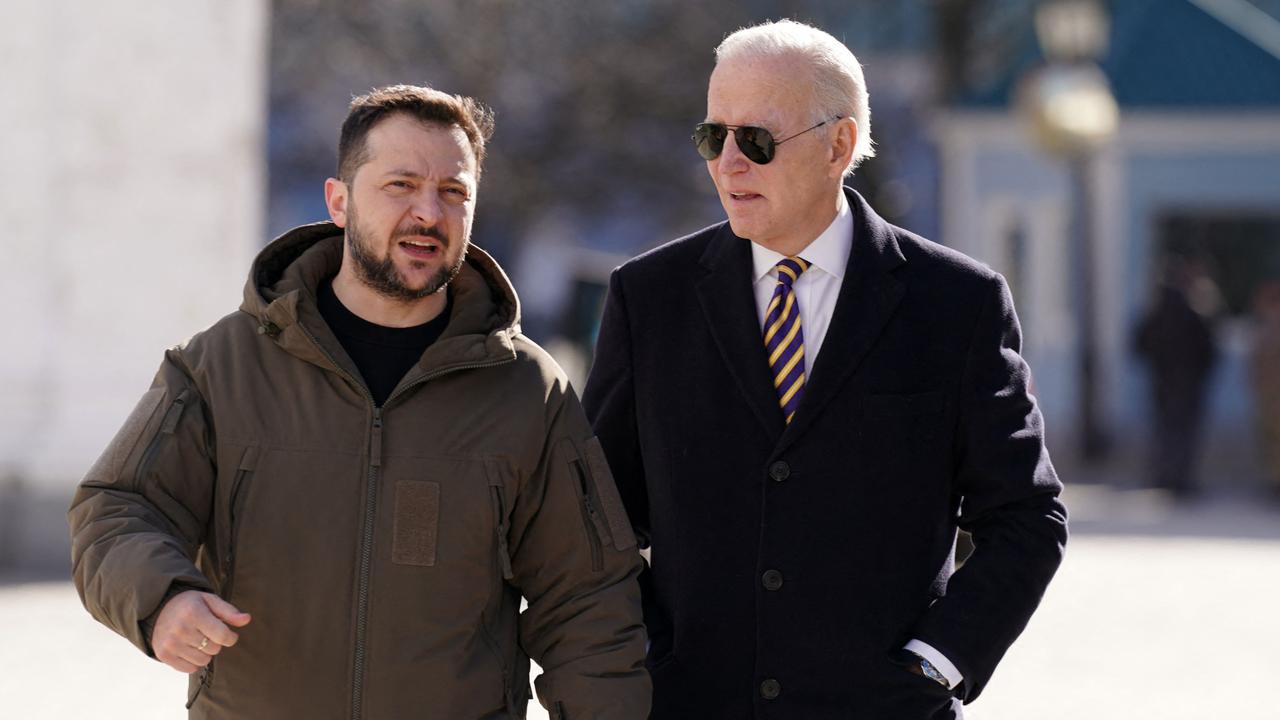 US President Joe Biden walks next to Ukrainian President Volodymyr Zelensky. (Photo by Dimitar DILKOFF / AFP)