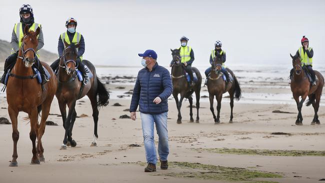 Champion trainer Danny O'Brien on 13th Beach Barwon Heads early morning training. Danny with 2019 Melbourne Cup winner Vow and Declare (left) on the beach during a workout. Picture: David Caird