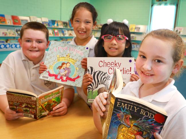 L-R Madang Ave Public School students Blake Colburn, 11, Alexis Rapana-Low, 6, Hollie Tadeo, 6 and Trinity Miner, 9. The school classrooms and library will receive airconditioning under a $500m program. (AAP Image / Angelo Velardo)