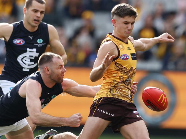 Sam Butler kicks at goal while being tackled by Sam Docherty in July 2023. Picture: Michael Klein.