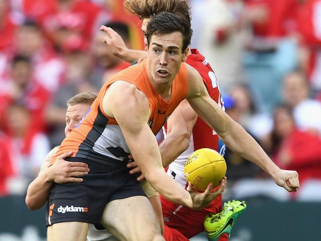 SYDNEY, AUSTRALIA - SEPTEMBER 10:  Jeremy Cameron of the Giants handballs whilst being tackled by Daniel Hannebery of the Swansduring the AFL 1st Qualifying Final match between the Sydney Swans and the Greater Western Sydney Giants at ANZ Stadium on September 10, 2016 in Sydney, Australia.  (Photo by Quinn Rooney/Getty Images)
