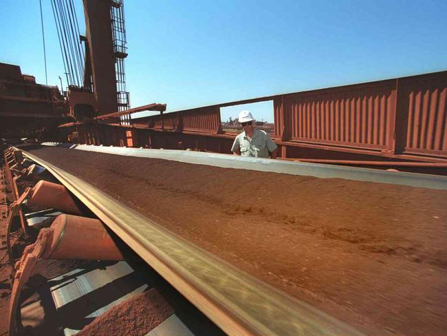 FILE - In this undated file photo released by BHP Billiton, a worker watches a conveyer belt as iron ore is taken from Mining Area C in the Pilbara in Western Australia. Anglo-Australian miner Rio Tinto PLC on Friday, June 5, 2009 scrapped its US$19.5 billion deal with Chinese firm Chinalco, choosing instead to raise US$15.2 billion in a share sale and setting up a joint production venture with rival BHP Billiton Ltd. (AP Photo/BHP Billiton, HO, File) ** EDITORIAL USE ONLY **