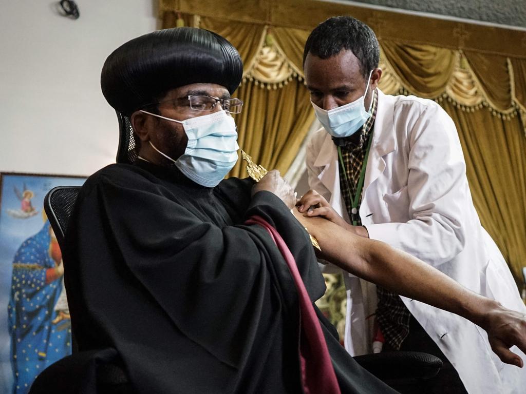 Ethiopian Orthodox high priest Abune Aregawi (L) receives the AstraZeneca in vaccine. Picture: AFP