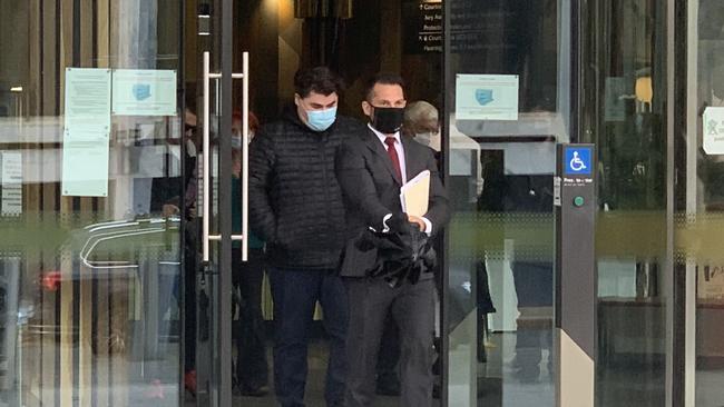 Angus Gottaas-Hughes (left) and lawyer James Maher (right) leaves the ACT Law Courts on April 7. Picture: Julia Kanapathippillai