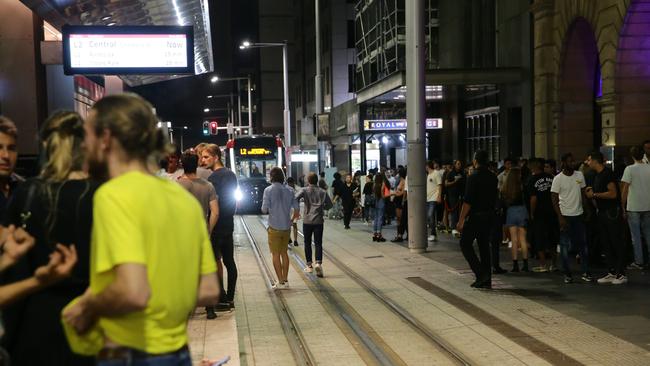 Crowds walking on George Street light rail tram tracks in Sydney. Picture: Bill Hearne