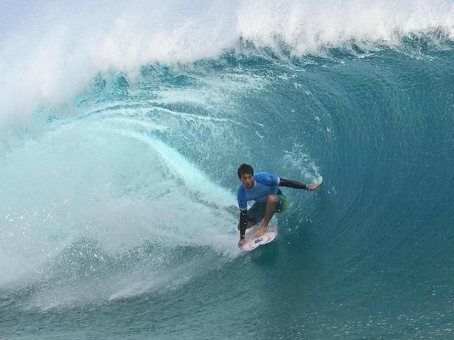 Robinson gets a barrel in the men's surfing gold medal final. Picture: Jerome Broulliet / AFP