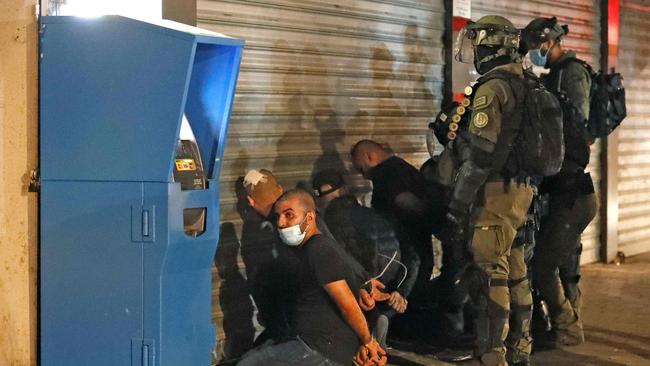 Israeli forces detain a group of Arab-Israelis in the mixed Jewish-Arab city of Lod on May 13, 2021, during clashes between Israeli far-right extremists and Arab-Israelis. Picture: Ahmad Gharabli/AFP