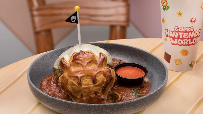At the Toadstool Cafe, you can get Bowser’s Fireball Challenge, a challenge featuring a towering one-pound meatball topped with gooey mozzarella cheese in rich mushroom marinara sauce and fresh parsley served with a Bowser-inspired puff pastry and a side of hot sauce. Photo: Universal Epic Universe