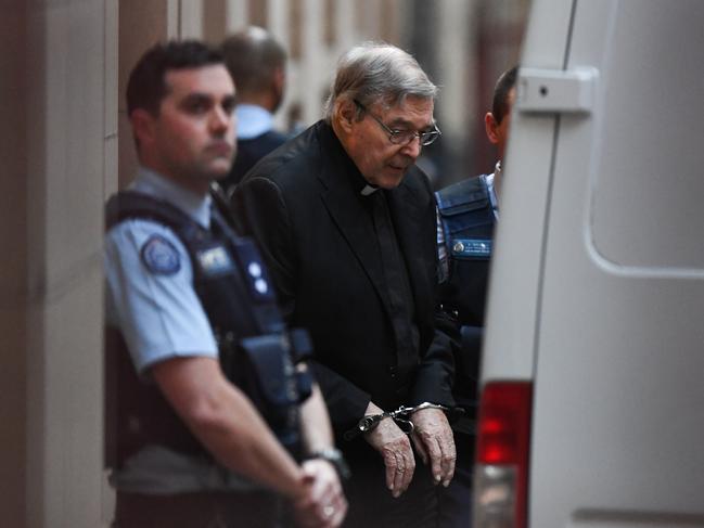 George Pell leaves the Supreme Court of Victoria in handcuffs last June. Picture: AAP