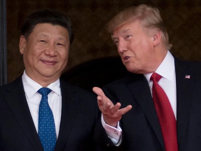 (FILES) In this file photo taken on April 06, 2017 US President Donald Trump (R) welcomes Chinese President Xi Jinping (L) to the Mar-a-Lago estate in West Palm Beach, Florida. - US President Donald Trump said on December 20, 2019 he'd had a "very good talk" with his Chinese counterpart Xi Jinping on a partial resolution of the countries' huge trade war. Trump tweeted that China "already started large scale" increases in purchases of US farm goods, in line with the deal. However, he did not give a date for when the so-called "phase one" agreement will actually be signed. (Photo by JIM WATSON / AFP)