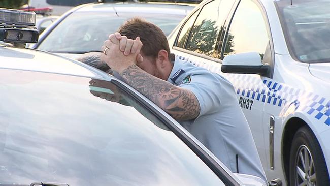 A police officer at the scene overcome with emotion. Picture: Supplied