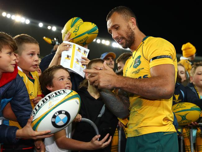 Quade Cooper signs autographs following the Scotland clash.