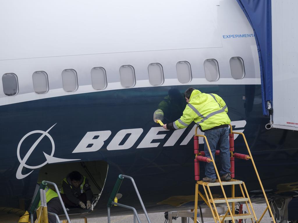 An employee works on the fuselage of a Boeing 737 MAX 9 test plane. outside the company's factory in Renton, Washington. Picture: AFP