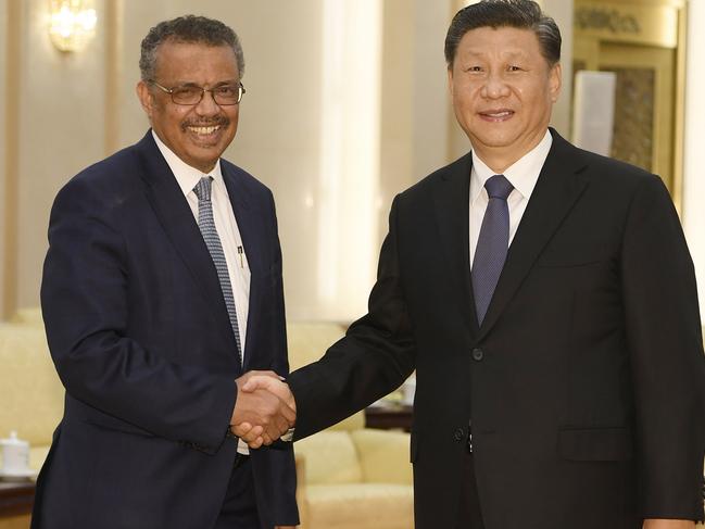 World Health Organization director general Tedros Adhanom shakes hands with Chinese President Xi Jinping. Picture: AFP