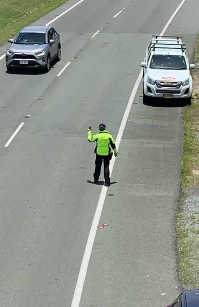 Senior Sergeant Bradyn Murphy, of the Gold Coast Road Policing Unit, pulls over NSW-registered vehicles at the border on Saturday as the Sydney northern beaches COVID-19 outbreak worsens. Picture: Greg Stolz