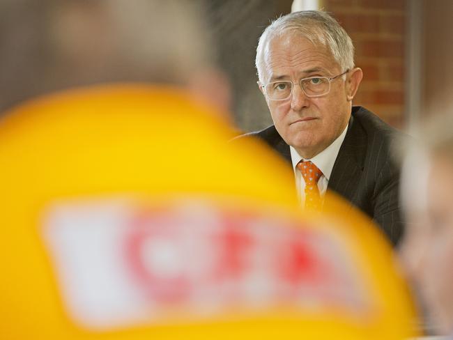 Prime Minister Malcolm Turnbull listens to CFA volunteers in Geelong. Picture: Nathan Dyer