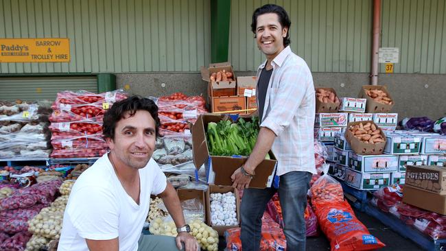 John De Giusti, left, with support worker Leonardo Camacho at Paddy’s Markets in Sydney. Picture: Hollie Adams