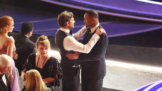 Bradley Cooper comforts Will Smith after the incident. Picture: Myung Chun / Los Angeles Times via Getty Images