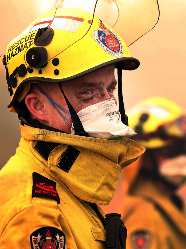 NSW Fire and Rescue Firefighter Peter Ince at with a colleague after battling a blaze on the Pacific Highway. Picture: Jane Dempster