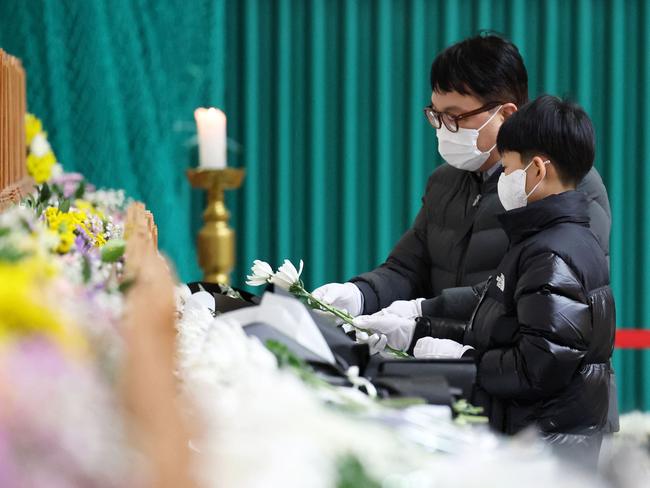 Mourners pay their respects at the site. Picture: AFP