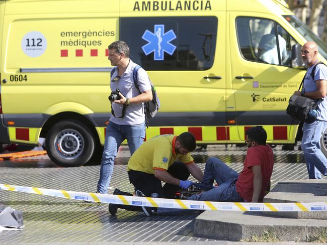 An injured person is treated in Barcelona, Spain. Picture: AP