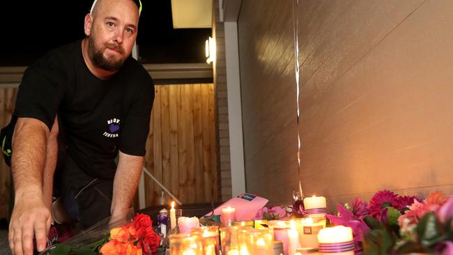 Darren O'Brien, brother of Teresa Bradford places flowers in front of her residence in Matas Drive where she died in a murder-suicide during a candlelight vigil, Pimpama, Gold Coast. Photo: Regi Varghese