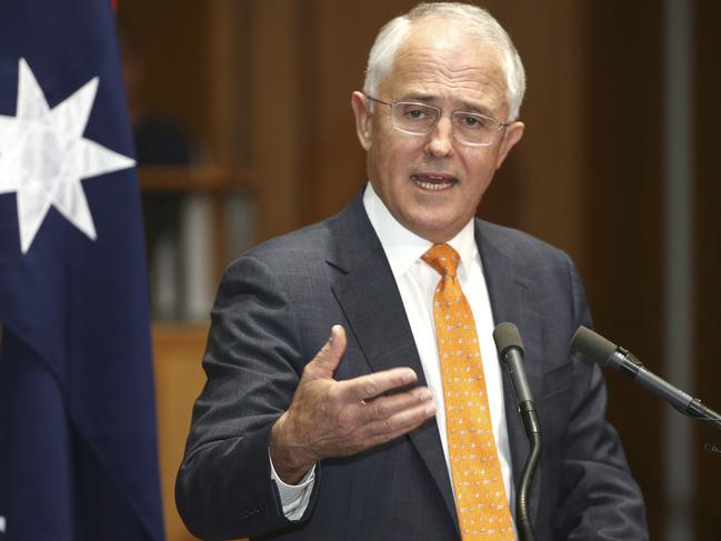 Prime Minister Malcolm Turnbull holds his hand out as he speaks to the media during a press conference at Parliament House in Canberra, Australia, Sunday, May 8, 2016. Turnbull officially announced a double dissolution election on July 2, 2016 and put economic management at the forefront of his campaign to win a second three-year term for his conservative coalition during era of extraordinary volatility in Australian politics. (AP Photo/Rob Griffith)