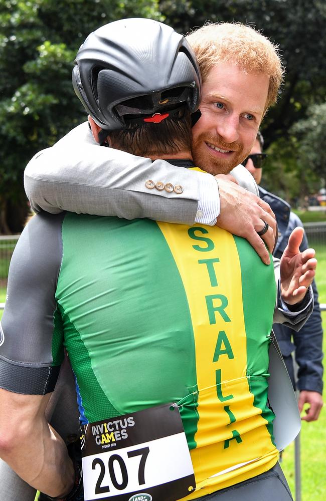 Britain's Prince Harry, the Duke of Sussex hugs Australian Invictus cyclist Michael Lyddiard during the Invictus Games in Sydney. Picture: AAP