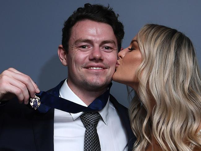 BRISBANE, AUSTRALIA - OCTOBER 18: Lachie Neale of the Lions poses with his wife Julie Neale after winning the Brownlow Medal at the Gabba during the 2020 AFL Brownlow Medal count on October 18, 2020 in Brisbane, Australia.  (Photo by Quinn Rooney/Getty Images)