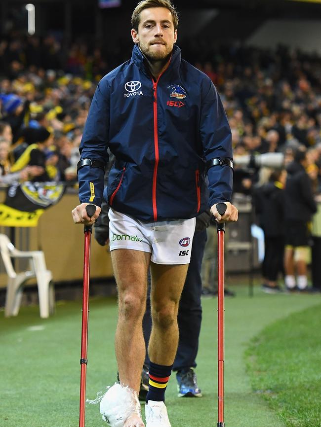 Richard Douglas of the Crows walks into the rooms on crutches during the clash with Richmond. Picture: Quinn Rooney/Getty Images