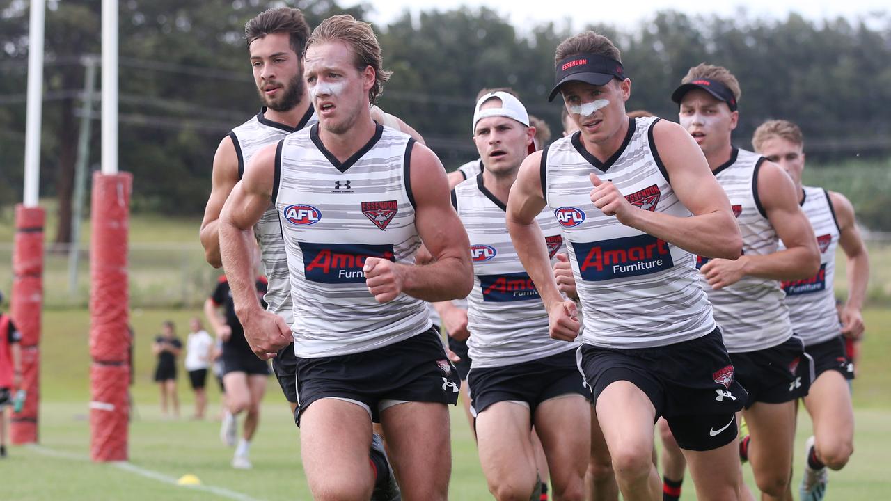 Darcy Parish leads his Essendon teammates in a run in Coffs Harbour. Picture: Getty Images