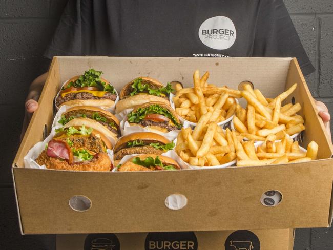 Catering box of burger and seasoned chips. Picture: Ted Seal